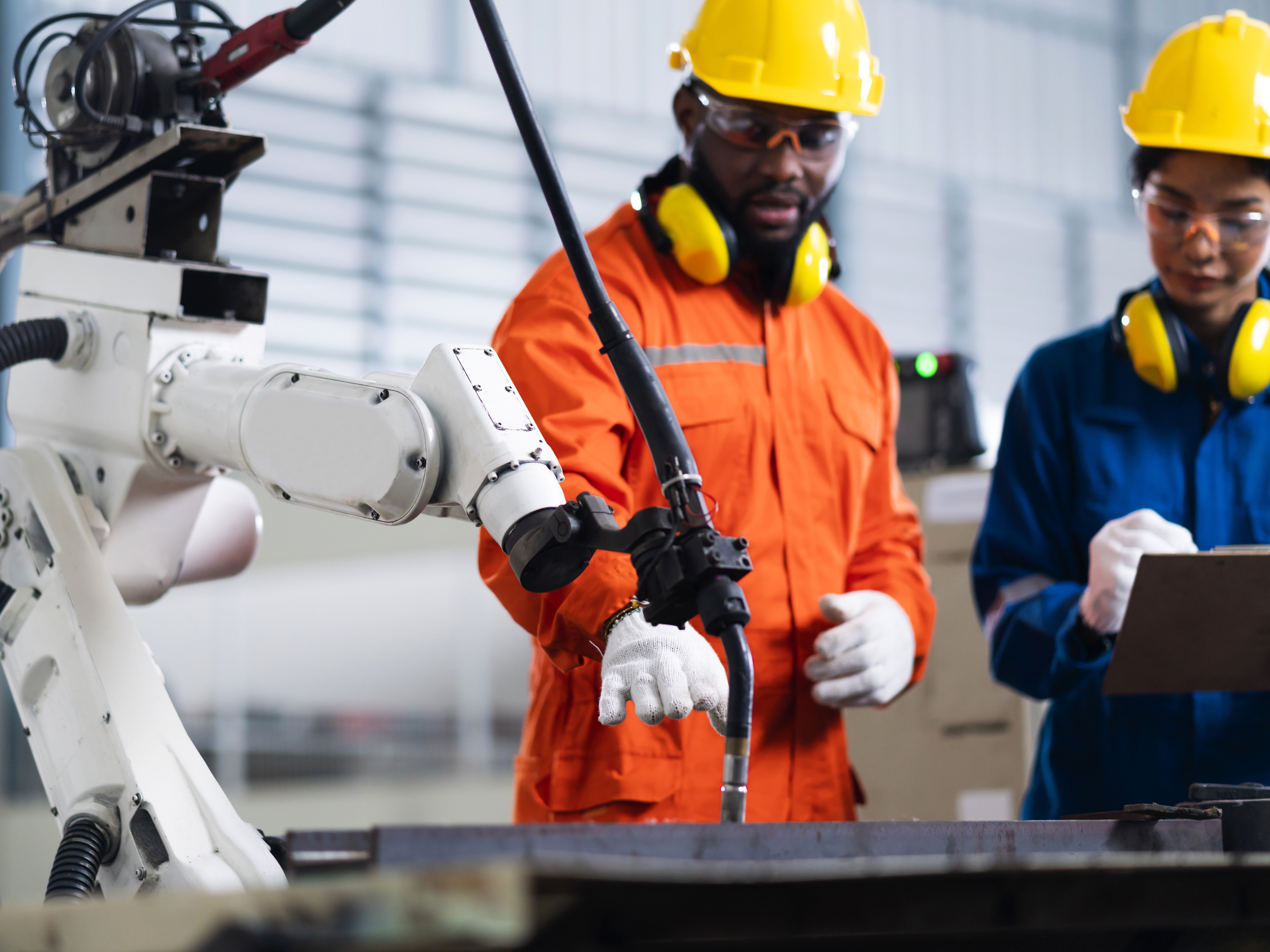 workers-operating-a-robotic-arm